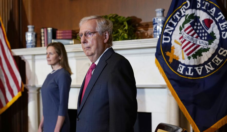 Senate Majority Leader Mitch McConnell of Ky., meets with Supreme Court nominee Judge Amy Coney Barrett on Capitol Hill in Washington, Sept. 29, 2020. (AP Photo/Susan Walsh, Pool) **FILE**
