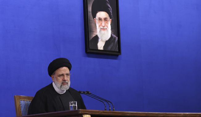 In this photo released by the official website of the office of the Iranian Presidency, President Ebrahim Raisi sits under a portrait of the Supreme Leader Ayatollah Ali Khamenei during a press conference in Tehran, Iran, Monday, Aug. 29, 2022. In a rare news conference Monday marking his first year in office, Raisi warned that any roadmap to restore Tehran&#x27;s tattered nuclear deal with world powers must see international inspectors end their probe on man-made uranium particles found at undeclared sites in the country. (Iranian Presidency Office via AP)