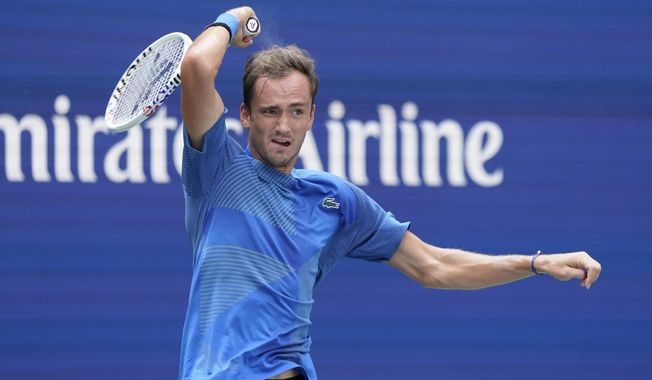 Daniil Medvedev, of Russia, returns a shot to Stefan Kozlov, of the United States, during the first round of the US Open tennis championships, Monday, Aug. 29, 2022, in New York. (AP Photo/John Minchillo)