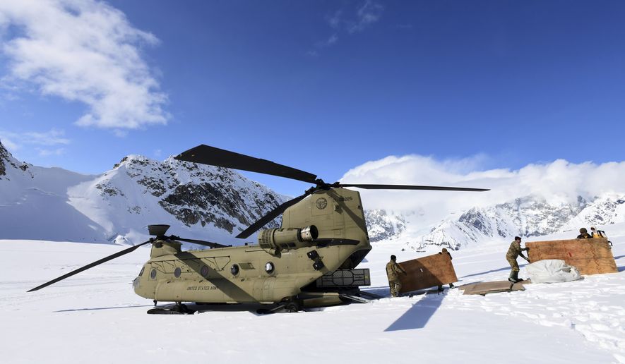 Soldiers and National Park Service personnel offload equipment and supplies from a U.S. Army CH-47 Chinook helicopter on Kahiltna Glacier on April 27, 2022. The Army says it has grounded its fleet of Chinook cargo helicopters after fuel leaks caused a &quot;small number&quot; of engine fires. (John Pennell/U.S. Army via AP, File)