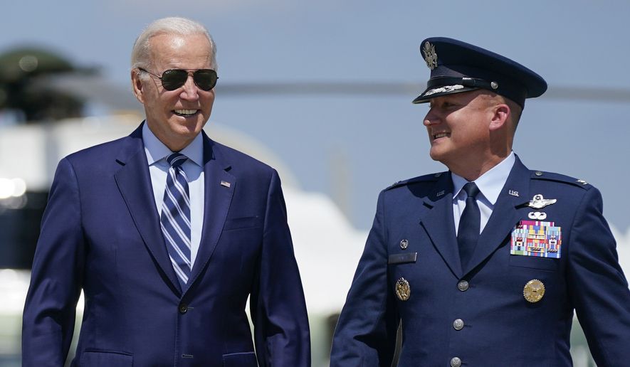 President Joe Biden walks toward Air Force One with Col. Matthew Jones, Commander, 89th Airlift Wing, Tuesday, Aug. 30, 2022, at Andrews Air Force Base, Md.  (AP Photo/Evan Vucci)