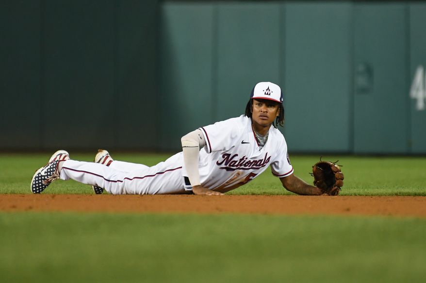 Washington Nationals shortstop CJ Abrams (5) on the ground after diving after Oakland A's left fielder Tony Kemp’s (5) single during the 5th inning at Nationals Park in Washington D.C., August 30, 2022. (Photo by All-Pro Reels)