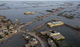 Homes are surrounded by floodwaters in Sohbat Pur city, a district of Pakistan&#39;s southwestern Baluchistan province, Monday, Aug. 29, 2022. Disaster officials say nearly a half million people in Pakistan are crowded into camps after losing their homes in widespread flooding caused by unprecedented monsoon rains in recent weeks. (AP Photo/Zahid Hussain)