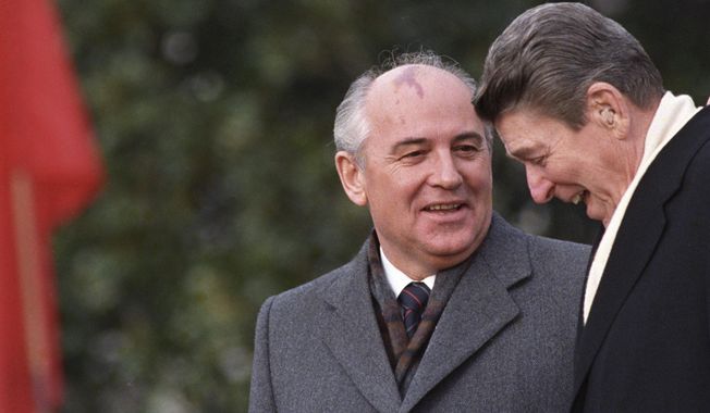 U.S. President Ronald Reagan, right, talks with Soviet leader Mikhail Gorbachev during arrival ceremonies at the White House where the superpowers begin their three-day summit talks in Washington, D.C., Tuesday, Dec. 8, 1987. Russian news agencies are reporting that former Soviet President Mikhail Gorbachev has died at 91. The Tass, RIA Novosti and Interfax news agencies cited the Central Clinical Hospital. (AP Photo/Boris Yurchenko, File)