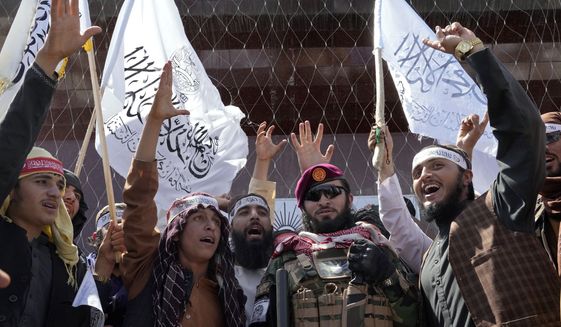 Taliban fighters chant slogans during a celebration marking the first anniversary of the withdrawal of US-led troops from Afghanistan, in front of the U.S. Embassy in Kabul, Afghanistan, Wednesday, Aug. 31, 2022. (AP Photo/Ebrahim Noroozi)