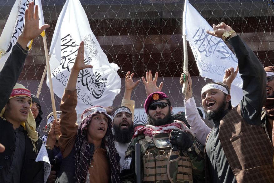 Taliban fighters chant slogans during a celebration marking the first anniversary of the withdrawal of US-led troops from Afghanistan, in front of the U.S. Embassy in Kabul, Afghanistan, Wednesday, Aug. 31, 2022. (AP Photo/Ebrahim Noroozi)