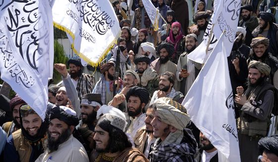 Taliban fighters celebrate the first anniversary of the withdrawal of US-led troops from Afghanistan, in front of the U.S. Embassy in Kabul, Afghanistan, Wednesday, Aug. 31, 2022. (AP Photo/Ebrahim Noroozi)