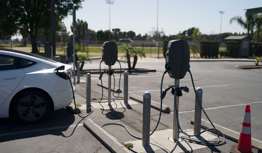 Electric vehicle chargers are seen in the parking lot of South El Monte High School in South El Monte, Calif., Friday, Aug. 26, 2022. Discounted prices, car-share programs, and a robust network of public charging stations are among the ways California will try to make electric vehicles affordable and convenient for people of all income levels as it phases out the sale of new gas cars by 2035. Advocates for the policy say the switch from gas- to battery-powered cars is a necessary step to reducing pollution in disadvantaged neighborhoods, but that the state make sure those residents can access the cars, too.(AP Photo/Jae C. Hong)