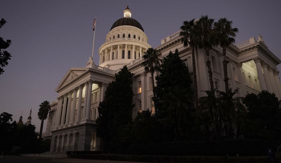 The lights of the state Capitol glow into the night in Sacramento, Calif., Wednesday, Aug. 31, 2022. Lawmakers have until midnight Wednesday to meet the deadline to complete their work for the 2021-2022 session. (AP Photo/Rich Pedroncelli)