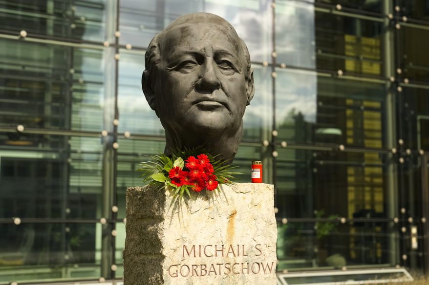 Flowers and a candle are placed at a bust of the former Soviet President Mikhail Gorbachev at the Axel Springer Publisher House in Berlin, Germany, Wednesday, Aug. 31, 2022. Russian news agencies reported that former Soviet President Mikhail Gorbachev has died at 91. The Tass, RIA Novosti and Interfax news agencies cited the Central Clinical Hospital. (AP Photo/Markus Schreiber) ** FILE **
