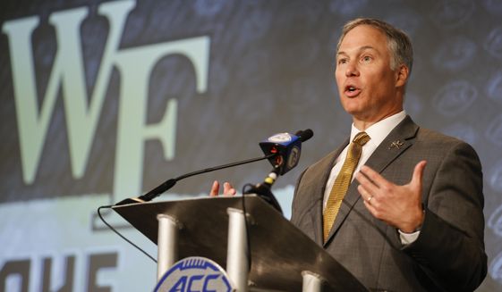 Wake Forest head coach Dave Clawson answers a question at the NCAA college football Atlantic Coast Conference Media Days in Charlotte, N.C., Wednesday, July 20, 2022. “You used to talk about graduation rates and majors,” Clawson said about recuiting. “Now the first question is, ‘What are you guaranteeing me year one, two, three and four?’” Clawson isn&#39;t necessarily talking about playing time, either. Prospects are far more familiar with ways they can profit off their fame through endorsement deals and are looking hard at whether schools can help them do it. (AP Photo/Nell Redmond, File)