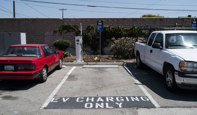 A parking spot reserved for electric vehicles is seen in the parking lot of a metro station in Norwalk, Calif., Monday, Aug. 29, 2022. Discounted prices, car-share programs, and a robust network of public charging stations are among the ways California will try to make electric vehicles affordable and convenient for people of all income levels as it phases out the sale of new gas cars by 2035. Advocates for the policy say the switch from gas- to battery-powered cars is a necessary step to reducing pollution in disadvantaged neighborhoods, but that the state make sure those residents can access the cars, too.(AP Photo/Jae C. Hong)