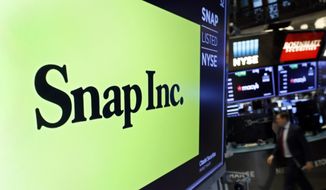The logo for Snap Inc. appears above a post on the floor of the New York Stock Exchange, Feb. 5, 2020. The parent company of social media platform Snapchat said Wednesday, Aug. 31, 2022, that it is letting go of 20% of its staff as it reorganizes and tries to reduce costs in the face of declining sales. In a letter to staff, CEO Evan Spiegel said sales were not keeping up with earlier projections and that the company had to reduce costs to avoid mounting losses. (AP Photo/Richard Drew, file)