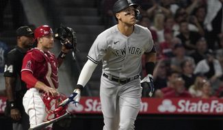 New York Yankees&#x27; Aaron Judge, right, drops his bat after hitting a three-run home run, next to Los Angeles Angels catcher Max Stassi and home plate umpire Alan Porter during the fourth inning of a baseball game Tuesday, Aug. 30, 2022, in Anaheim, Calif. (AP Photo/Mark J. Terrill)