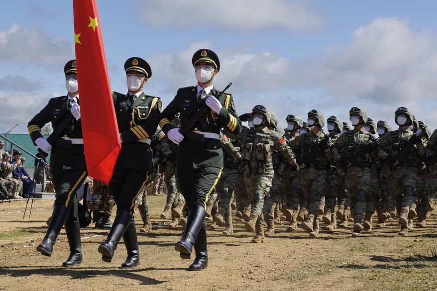 In this handout photo released by Russian Defense Ministry Press Service, Chinese troops march during the Vostok 2022 military exercise at a firing range in Russia&#x27;s Far East, Wednesday, Aug. 31, 2022. Russia on Thursday launched weeklong war games involving forces from China and other nations in a show of growing defense cooperation between Moscow and Beijing, as they both face tensions with the United States. (Vadim Savitsky/Russian Defense Ministry Press Service via AP)