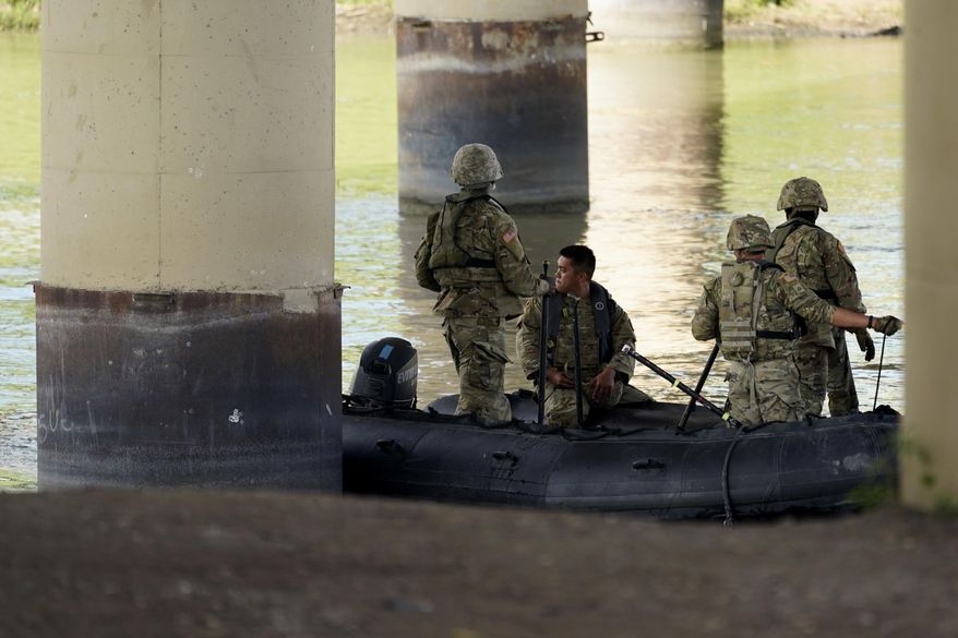 Texas National Guard help patrol looks the Rio Grande near Eagle Pass, Texas, Friday, Aug. 26, 2022. (AP Photo/Eric Gay) ** FILE **