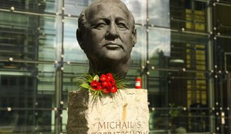 Flowers and a candle are placed at a bust of the former Soviet President Mikhail Gorbachev at the Axel Springer Publisher House in Berlin, Germany, Wednesday, Aug. 31, 2022. Russian news agencies are reporting that former Soviet President Mikhail Gorbachev has died at 91. The Tass, RIA Novosti and Interfax news agencies cited the Central Clinical Hospital. (AP Photo/Markus Schreiber)