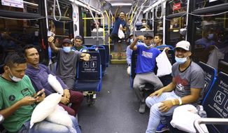 Migrants give a thumbs up and cheer as they load a bus to take them to a refugee center outside Union Station in Chicago, Wednesday, Aug. 31, 2022. Chicago officials say 75 immigrants have arrived in the city on buses from Texas, as part of an aggressive border policy by Texas Gov. Greg Abbott. Mayor Lori Lightfoot&#39;s office confirmed that the migrants arrived Wednesday night and that the city has welcomed them and will make sure they receive shelter and food. (Anthony Vazquez /Chicago Sun-Times via AP)