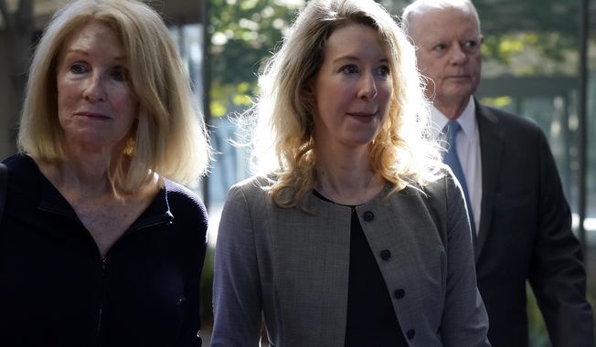 Former Theranos CEO Elizabeth Holmes, middle, and her mother, Noel Holmes, left, arrive at federal court in San Jose, Calif., Thursday, Sept. 1, 2022. (AP Photo/Jeff Chiu)