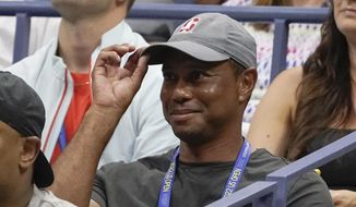 Tiger Woods tips his hat to the crowd during a match between Serena Williams, of the United States, and Anett Kontaveit, of Estonia, at the second round of the U.S. Open tennis championships, Wednesday, Aug. 31, 2022, in New York. (AP Photo/John Minchillo)