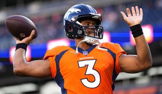 Denver Broncos quarterback Russell Wilson (3) warms up prior to an NFL preseason football game against the Minnesota Vikings, Saturday, Aug. 27, 2022, in Denver. (AP Photo/Jack Dempsey)