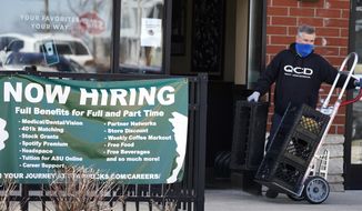 A hiring sign is displayed outside of a Starbucks in Schaumburg, Ill., Friday, April 1, 2022.  America’s employers added a healthy number of jobs last month, Friday, Sept. 2,  yet slowed their hiring enough to potentially help the Federal Reserve in its fight to reduce raging inflation. The economy gained 315,000 jobs in August, a still-solid figure that pointed to an economy that remains resilient despite rising interest rates, high inflation and sluggish consumer spending. (AP Photo/Nam Y. Huh)