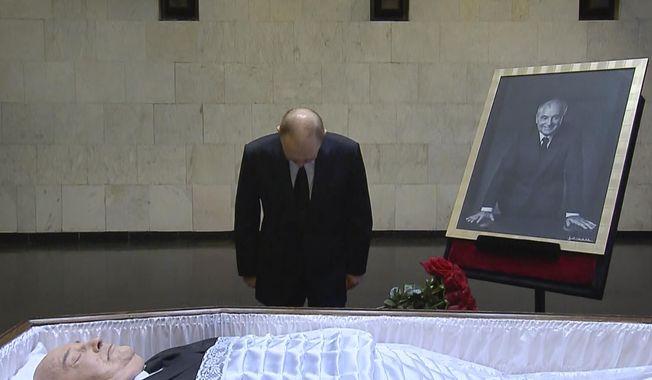 In this image from video provided by the Russian pool television on Thursday, Sept. 1, 2022, Russian President Vladimir Putin pays his respects at the coffin of former Soviet President Mikhail Gorbachev at the Central Clinical Hospital in Moscow Russia. (Russian pool via AP)