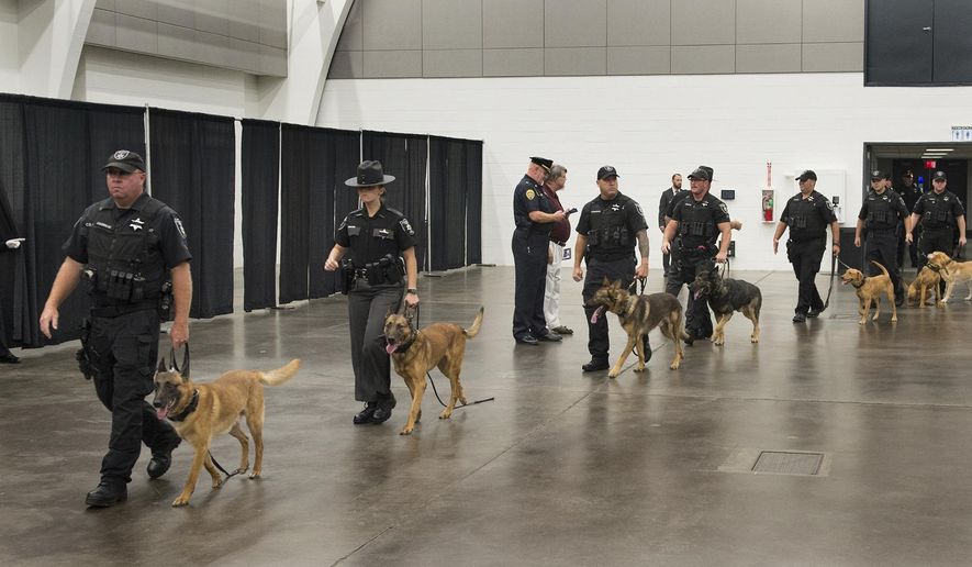 Kanawha County Sheriff police dogs and their handlers file into the Charleston Coliseum and Convention Center's Great Hall in Charleston, W.Va., for the funeral of Charleston police K-9 Axel on Thursday, Sept.1, 2022. Axel was shot as his handler attempted to arrest a man late Saturday Aug. 27. The suspect was shot and killed by officers. (Chris Dorst/Charleston Gazette-Mail via AP)