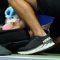 Rafael Nadal, of Spain, is treated by a trainer during a medical timeout during a match against Fabio Fognini, of Italy, during the second round of the U.S. Open tennis championships, early Friday, Sept. 2, 2022, in New York. Nadal&#39;s racket head rebounded off the court and hit his nose. (AP Photo/Frank Franklin II)