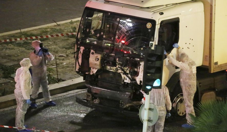 In this July 14, 2016 file photo, authorities investigate a truck after it plowed through Bastille Day revelers in the French resort city of Nice, France, killing 86 people. (Sasha Goldsmith via AP, File)
