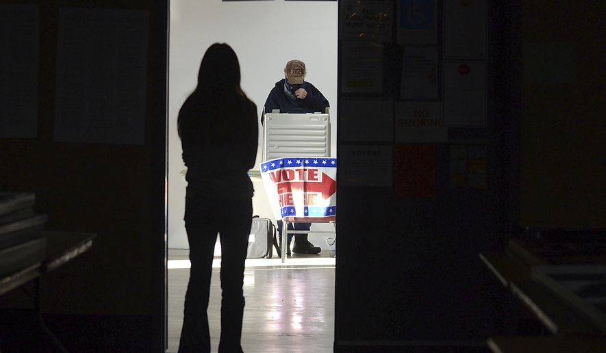 First-time voter Baylee Fidler, 19, waits in the doorway for a voting booth as Tom Davis, background, completes his ballot at the Boot City Opry near Terre Haute, Ind., on Tuesday, Nov. 3, 2020. As the 2022 midterm elections enter their final two-month sprint, leading Republicans concede that their party&#39;s advantage may be slipping even as Democrats confront their president&#39;s weak standing, deep voter pessimism and the weight of history this fall. (Joseph C. Garza/The Tribune-Star via AP)