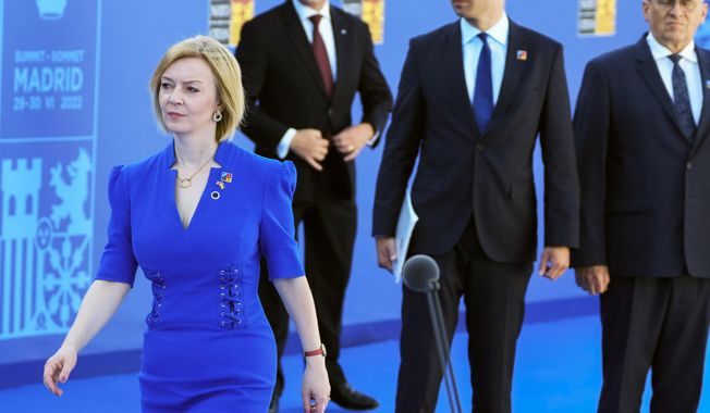 British Foreign Secretary Liz Truss, left, arrives for the NATO summit in Madrid, Spain on Wednesday, June 29, 2022. (AP Photo/Paul White, File)