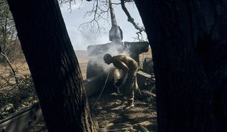 A Ukrainian soldier fires on the front line in the Donetsk region, eastern Ukraine, Sat. Sept. 3, 2022. (AP Photo/Kostiantyn Liberov)