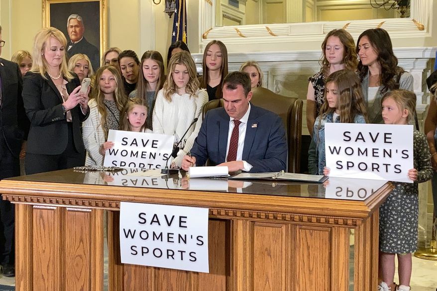 In this March 30, 2022 file photo Oklahoma Gov. Kevin Stitt signs a bill in Oklahoma City that prevents transgender girls and women from competing on female sports teams.
Attorneys for three Oklahoma students filed a federal lawsuit on Sept. 7, 2022, against the state’s newly enacted single-sex school restroom law, arguing that it discriminates against transgender pupils.(AP Photo/Sean Murphy, File) **FILE*
