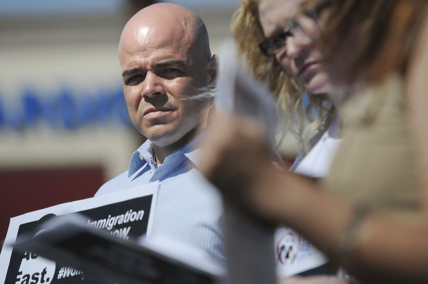 In this March 24, 2014, file photo, Immigration Reform for Nevada supporter Robert Telles is seen during an event outside the office of U.S. Rep. Joe Heck, R-Nev., in protest of Congress not taking action on comprehensive immigration reform. Police say they are serving search warrants in connection with the fatal stabbing of a Las Vegas newspaper reporter last week. In a statement Wednesday, Sept. 7, 2022 Metro Police didn’t specify where they were searching in connection with the death of reporter Jeff German. But the Las Vegas Review-Journal reported  uniformed officers and police vehicles were seen outside the home of Clark County Public Administrator Robert Telles (Erik Verduzco/Las Vegas Review-Journal via AP) ** FILE **