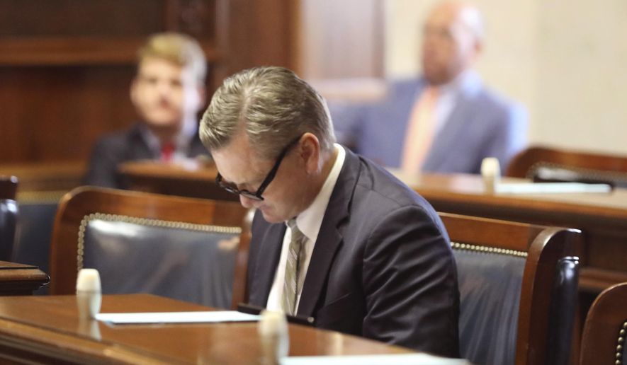 Republican South Carolina Sen. Tom Davis looks over papers at his desk before debate about a bill banning abortion on Wednesday, Sept. 7, 2022, in Columbia, S.C. (AP Photo/Jeffrey Collins)