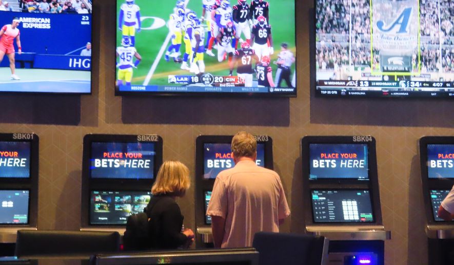 A customer makes a sports bet at the Ocean Casino Resort in Atlantic City, N.J. on Sept. 6, 2022. In the fifth year of legal sports betting in most U.S. states, the action is speeding up due to microbetting, the ability to place a bet on an outcome as narrowly targeted as the result of the next pitch in baseball or the next play in football. (AP Photo/Wayne Parry)