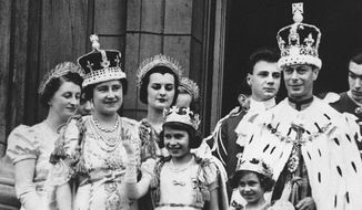 Princess Elizabeth, center, age 11, appears on the balcony of Buckingham Palace after the coronation of her father, King George VI, right, in London, May 12, 1937. Queen Elizabeth II, Britain’s longest-reigning monarch and a rock of stability across much of a turbulent century, has died. She was 96. Buckingham Palace made the announcement in a statement on Thursday Sept. 8, 2022. (AP Photo, File)