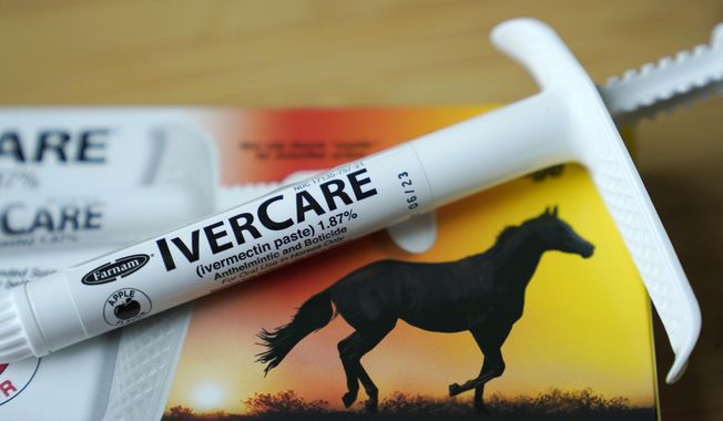 In this Sept. 10, 2021, file photo, a syringe of of ivermectin — a drug used to kill worms and other parasites — intended for use in horses only, rests on the box it was packaged in, in Olympia, Wash.  On Friday, Sept. 9, 2022, The Associated Press reported on stories circulating online incorrectly claiming the National Institutes of Health recently added ivermectin to a list of COVID-19 treatments.  (AP Photo/Ted S. Warren, File)