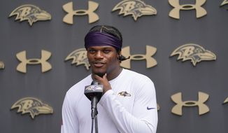 Baltimore Ravens quarterback Lamar Jackson talks to reporters during the team&#39;s NFL football training camp, Thursday, July 28, 2022, in Owings Mills, Md. The Baltimore quarterback is still without a contract extension beyond this season. (AP Photo/Julio Cortez, File)