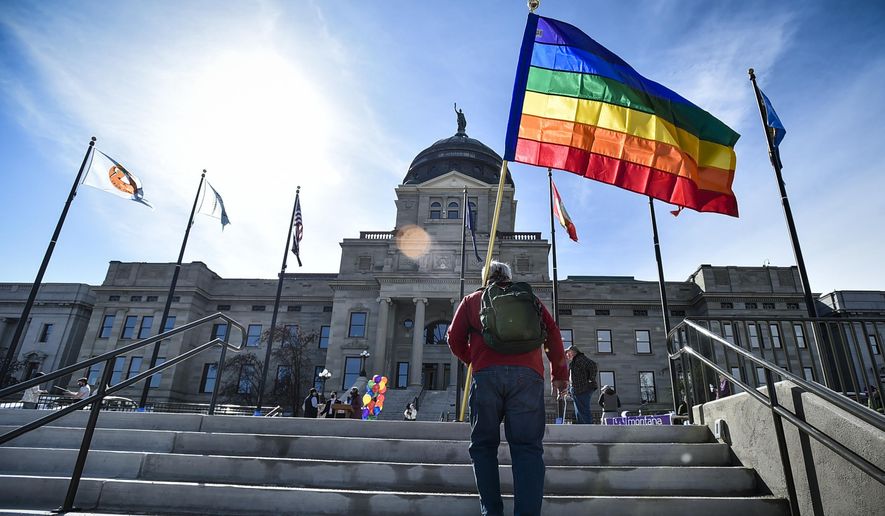 In this March 15, 2021 photo, demonstrators gather on the steps of the Montana State Capitol protesting anti-LGBTQ+ legislation in Helena, Mont. Montana health officials say transgender people can&#39;t change their birth certificates even if they undergo surgery, in defiance of a court order that temporarily blocked the Republican state&#39;s bid to restrict transgender rights. (Thom Bridge/Independent Record via AP, File)