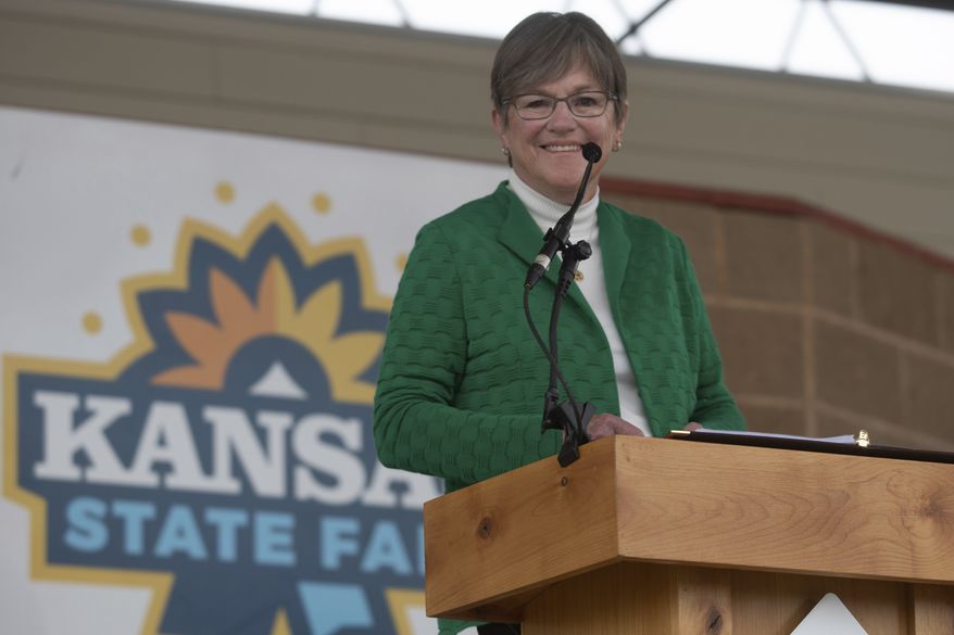Gov. Laura Kelly smiles as supporters chant her name before the start of a gubernatorial debate against Attorney General Derek Schmidt at the Kansas State Fair in Hutchinson, Kan., on Saturday, Sept. 10, 2022. (Evert Nelson/The Topeka Capital-Journal via AP) ** FILE **