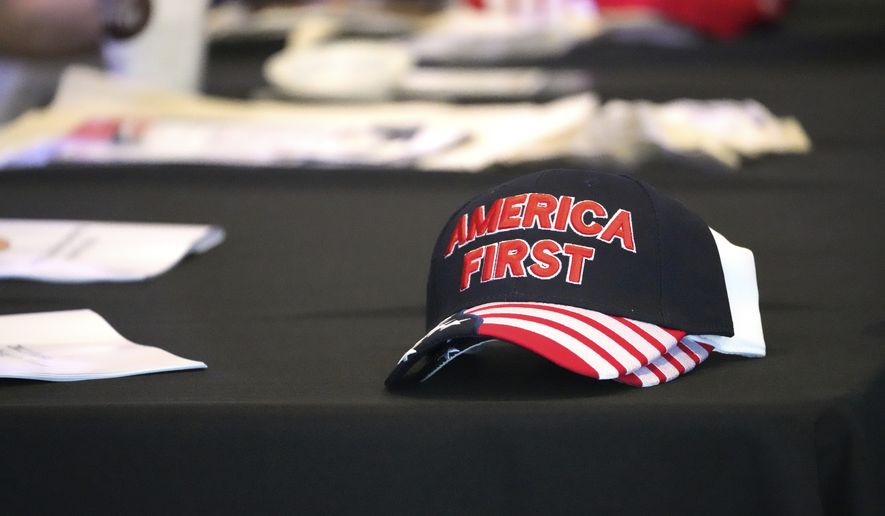 A hat with the words &quot;America First&quot; is displayed on a table during a conference on conspiracy theories about voting machines and discredited claims about the 2020 presidential election at a hotel in West Palm Beach, Fla., Saturday, Sept. 10, 2022. The event featured Republicans running for statewide offices that oversee elections in some of the most important battleground states. (AP Photo/Jim Rassol)
