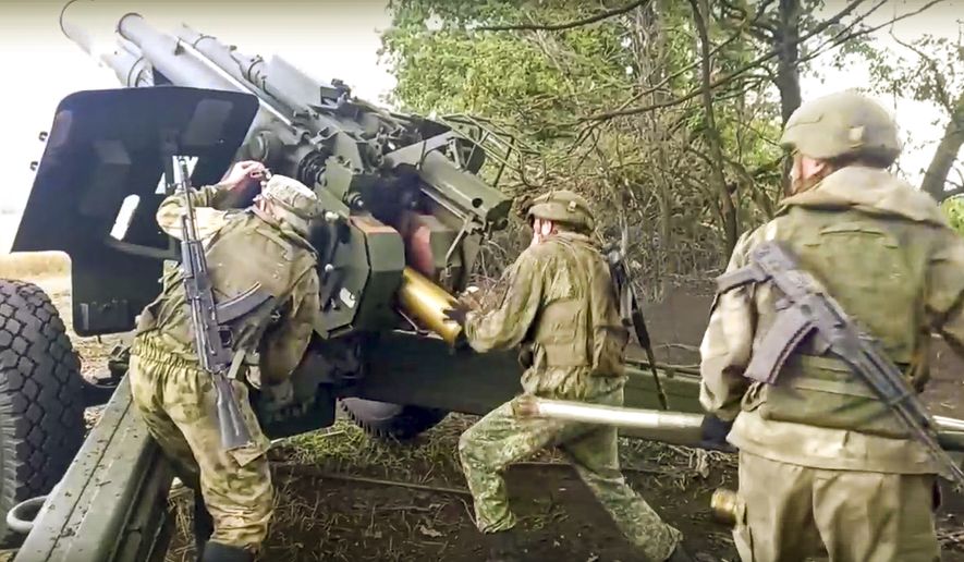 In this handout photo released by Russian Defense Ministry Press Service on Saturday, Sept. 10, 2022, Russian soldiers prepare to fire from Msta-B 152.4 mm howitzer from their position at an undisclosed location in Ukraine. (Russian Defense Ministry Press Service via AP)