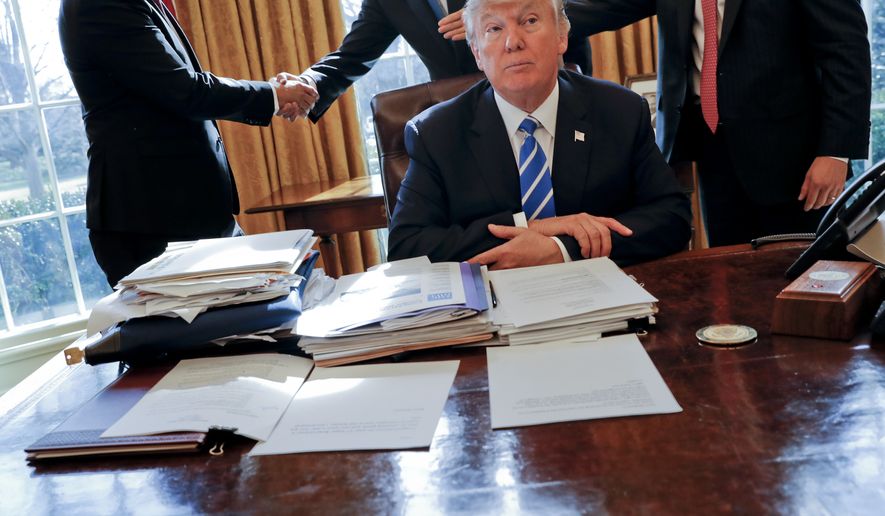 President Donald Trump sits at his desk after a meeting with Intel CEO Brian Krzanich, left, and members of his staff in the Oval Office of the White House in Washington, Feb. 8, 2017, as a lockbag is visible on the desk, the key still inside at left. Sen. Martin Heinrich, D-N.M., all but warned of Trump&#39;s handling of sensitive documents early in the then-president’s term. “Never leave a key in a classified lockbag in the presence of non-cleared people. #Classified101,” tweeted Heinrich, a member of the Intelligence Committee, days after the February 2017 incident. He asked for a review. (AP Photo/Pablo Martinez Monsivais, File)