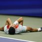 Carlos Alcaraz, of Spain, lays on the court after defeating Frances Tiafoe, of the United States, during the semifinals of the U.S. Open tennis championships, Friday, Sept. 9, 2022, in New York. (AP Photo/Charles Krupa)