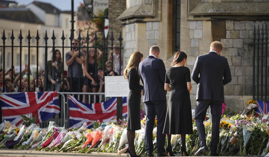 Britain&#39;s Prince William and Kate, Princess of Wales and Britain&#39;s Prince Harry and Meghan, Duchess of Sussex view the floral tributes for the late Queen Elizabeth II outside Windsor Castle, in Windsor, England, Saturday, Sept. 10, 2022. (AP Photo/Martin Meissner)