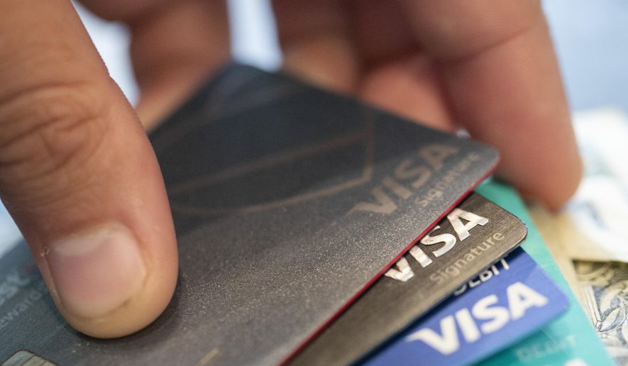 Visa credit cards are seen on Aug. 11, 2019, in New Orleans. Payment processor Visa Inc. said late Saturday, Sept. 10, 2022, that it plans to start separately categorizing sales at gun shops. (AP Photo/Jenny Kane, File)