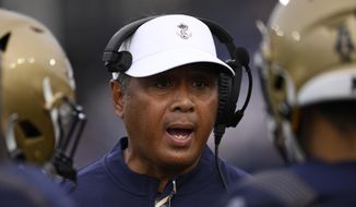 Navy head coach Ken Niumatalolo talks to his players during the second half of an NCAA college football game against Memphis, Saturday, Sept. 10, 2022, in Annapolis, Md. Memphis won 37-13. (AP Photo/Nick Wass) **FILE**