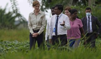 USAID administrator Samantha Power, left, speaks with agriculture specialists of UN&#39;s FAO and rice farmers during a visit to a paddy field in Ja-Ela on the outskirts of Colombo, Sri Lanka, Saturday, Sept. 10, 2022. (AP Photo/Eranga Jayawardena)